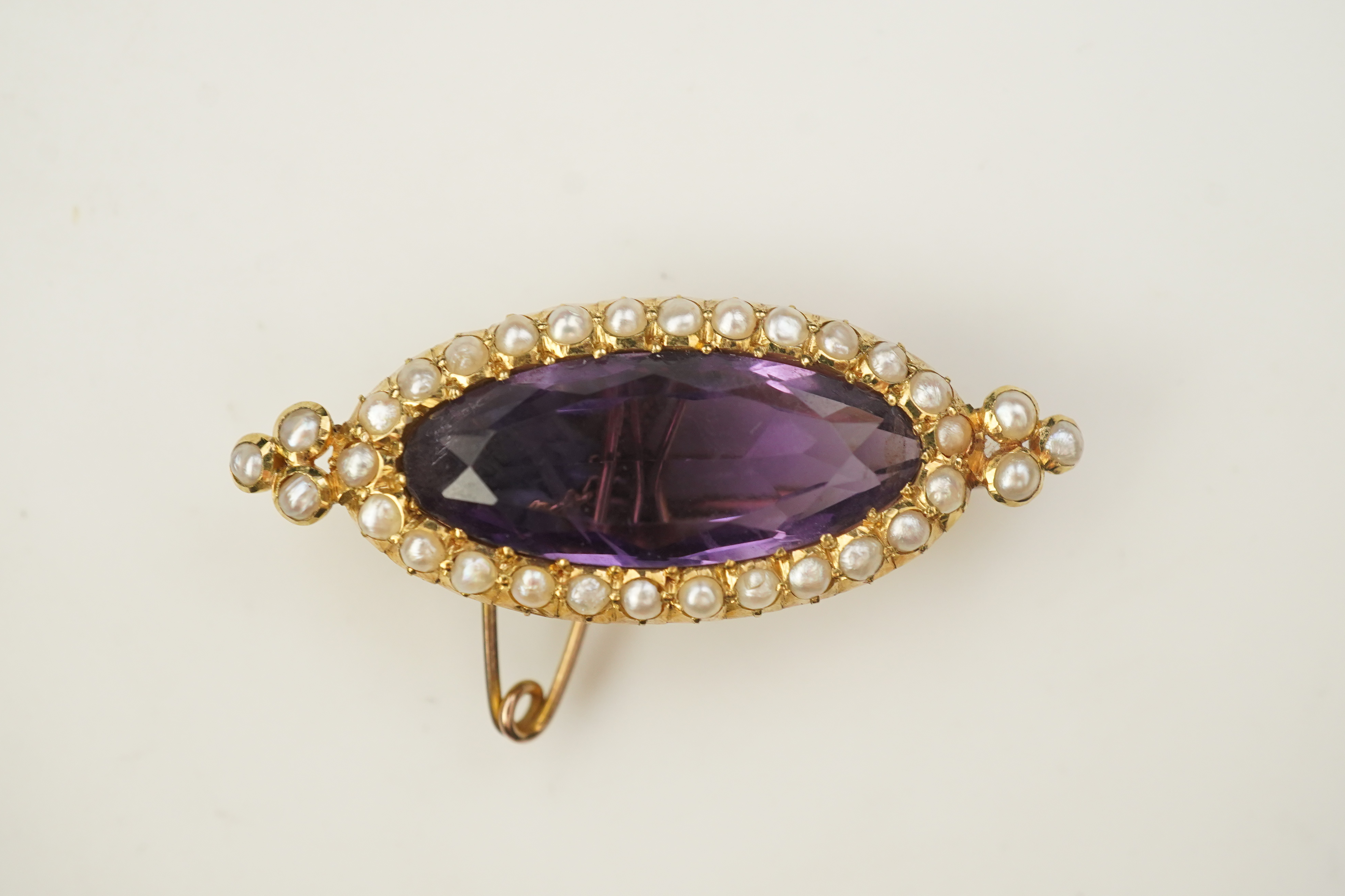 An amethyst and pearl brooch, circa 1900